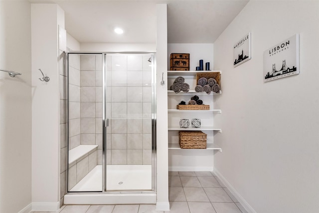 full bath featuring baseboards, a stall shower, and tile patterned floors