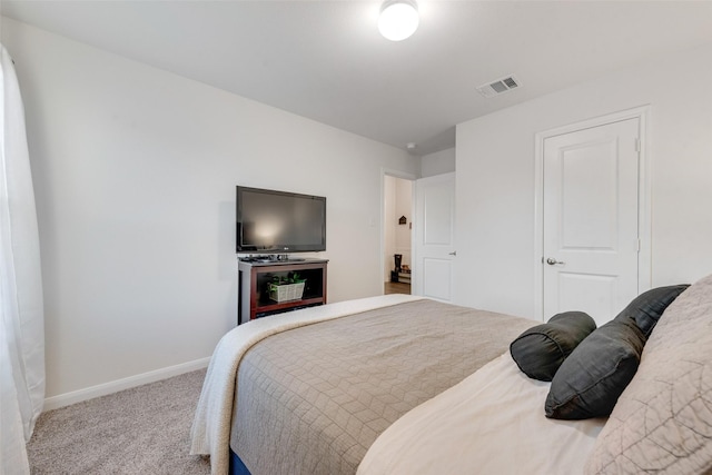 bedroom with baseboards, visible vents, and light colored carpet