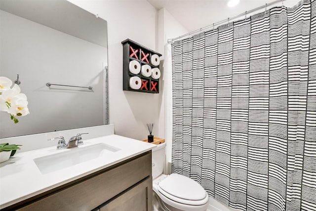 bathroom with a shower with shower curtain, vanity, and toilet