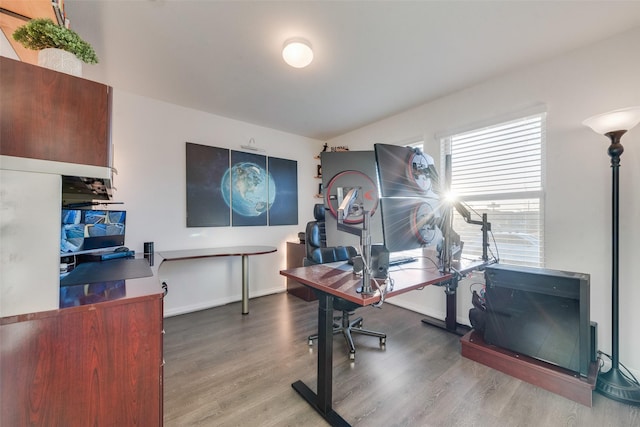 office space featuring baseboards and wood finished floors