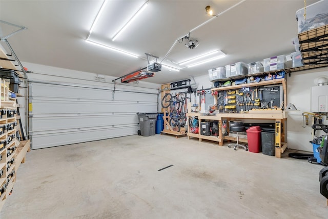 garage with tankless water heater, a workshop area, and a garage door opener