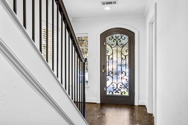 entrance foyer with crown molding and dark hardwood / wood-style flooring