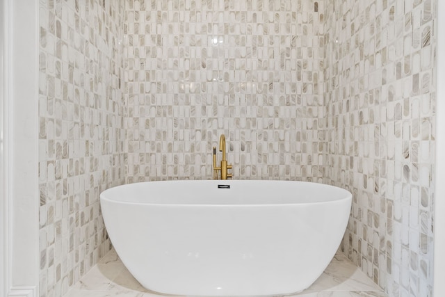 bathroom with tile walls and a washtub