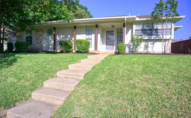 ranch-style house featuring a garage and a front lawn