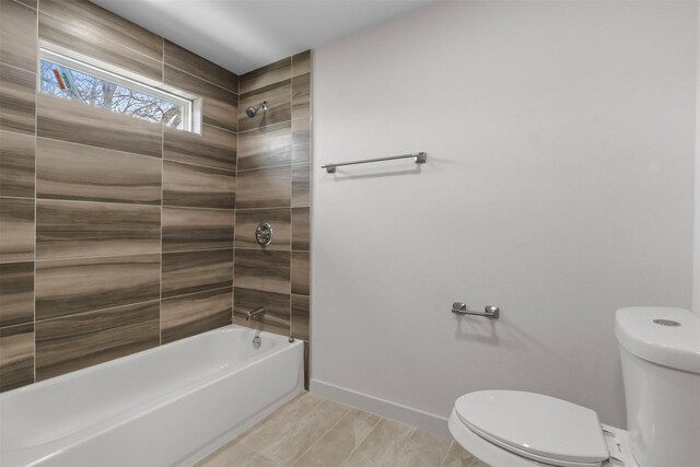 full bath featuring bathtub / shower combination, toilet, and baseboards