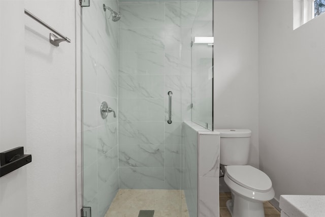 full bath featuring a shower stall and toilet