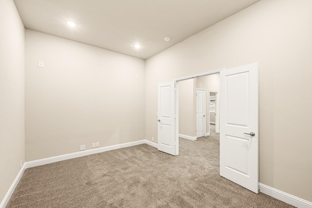 unfurnished room with recessed lighting, carpet, and baseboards