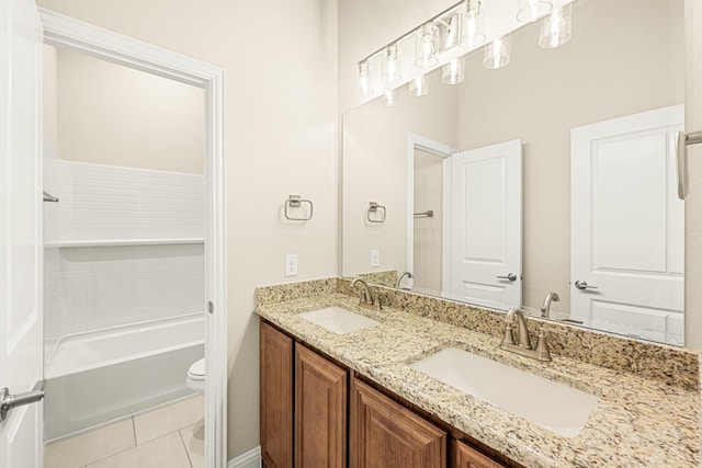 bathroom with double vanity, a sink, toilet, and tile patterned floors