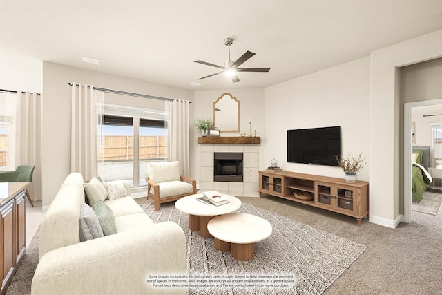 living room featuring light carpet, baseboards, a ceiling fan, and a tiled fireplace