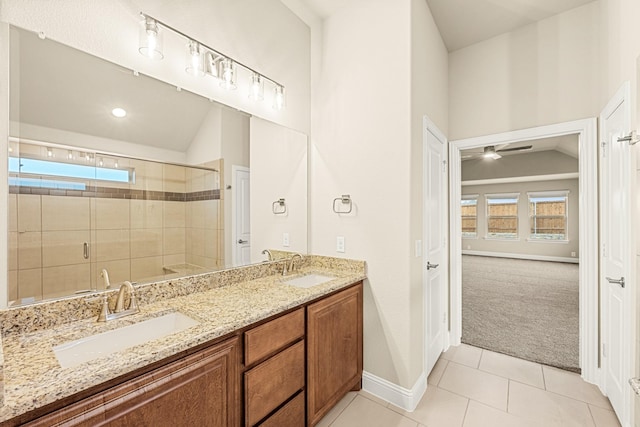 full bath featuring lofted ceiling, a sink, a shower stall, and tile patterned floors