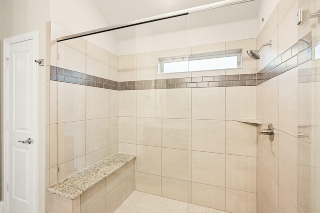 bathroom with tiled shower