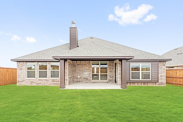 back of house featuring a patio area, a fenced backyard, a lawn, and brick siding