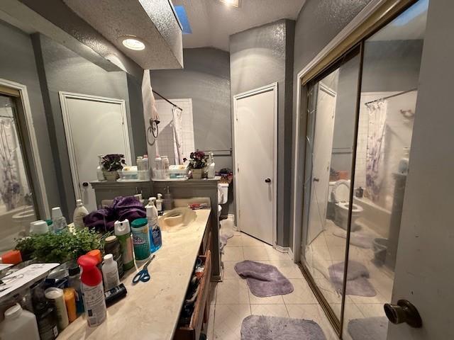 bathroom with vanity, tile patterned flooring, and a shower with shower curtain