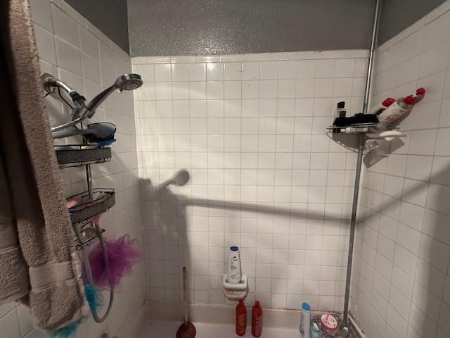 bathroom with tiled shower