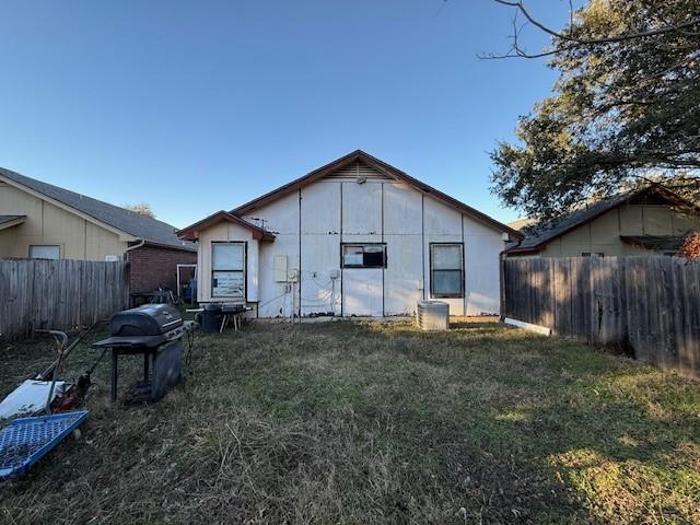 rear view of house with a yard