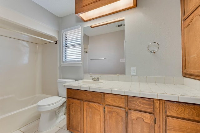 bathroom featuring vanity, toilet, and tile patterned flooring