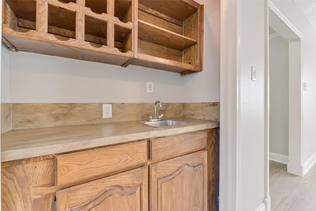 kitchen with sink and light hardwood / wood-style flooring