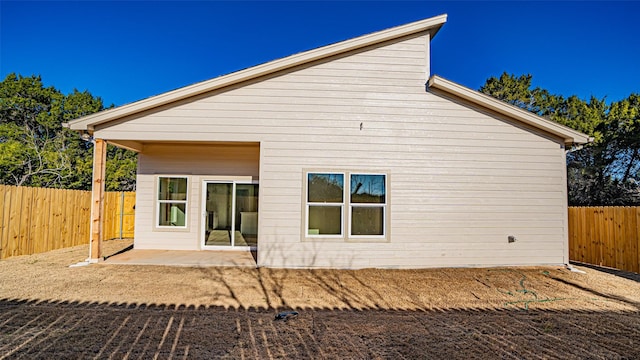 back of house with a patio