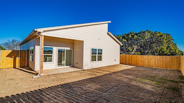 rear view of property featuring a patio