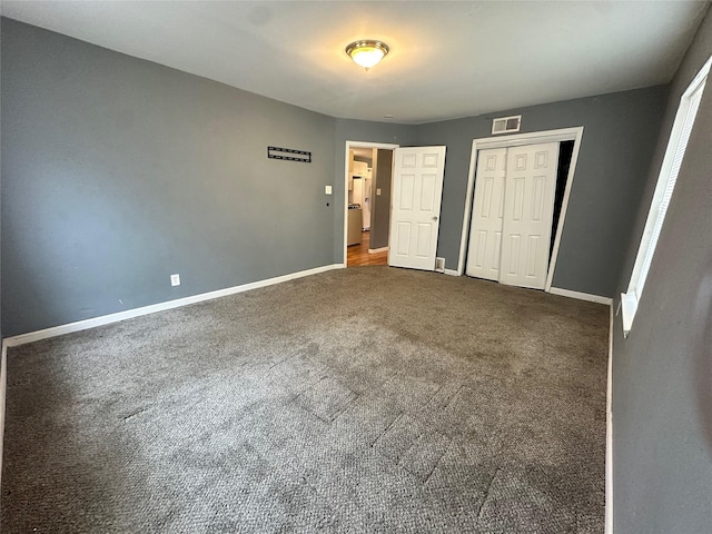 unfurnished bedroom with a closet and carpet