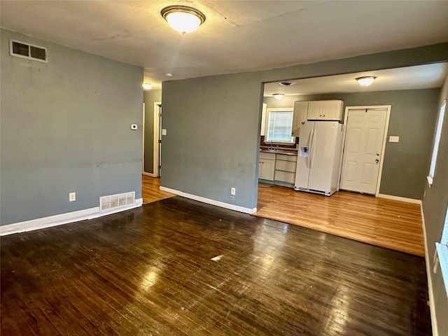 empty room with sink and hardwood / wood-style flooring