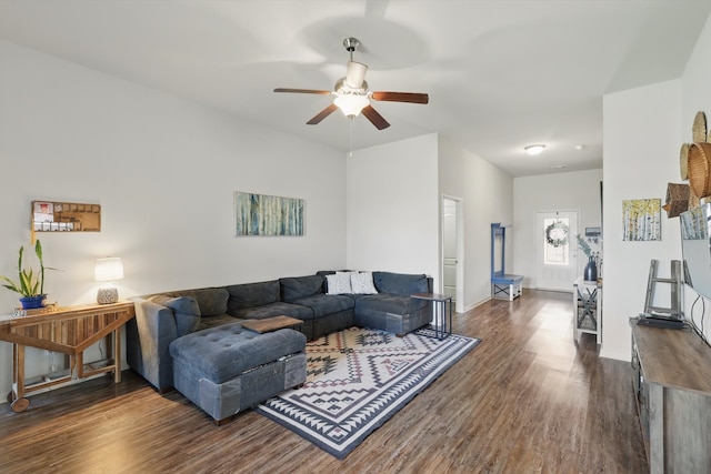 living area featuring ceiling fan, baseboards, and wood finished floors