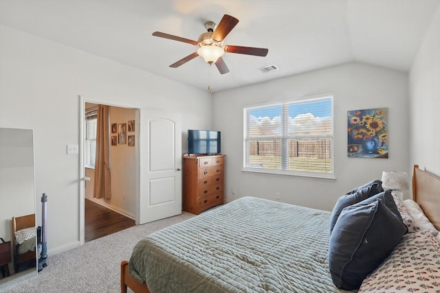 carpeted bedroom with lofted ceiling, visible vents, ceiling fan, and baseboards