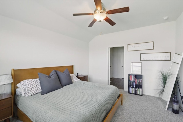 bedroom with vaulted ceiling, carpet floors, a ceiling fan, and baseboards