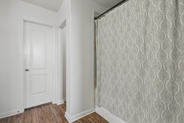 interior space with wood finished floors and baseboards