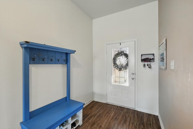 entryway with dark wood-style floors and baseboards