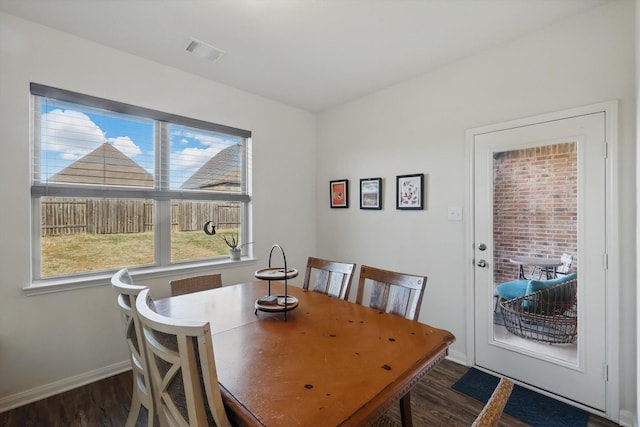 dining space featuring baseboards, visible vents, and wood finished floors