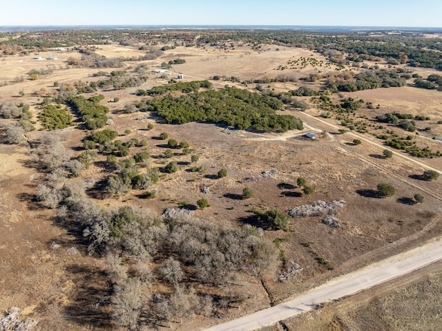 birds eye view of property with a rural view