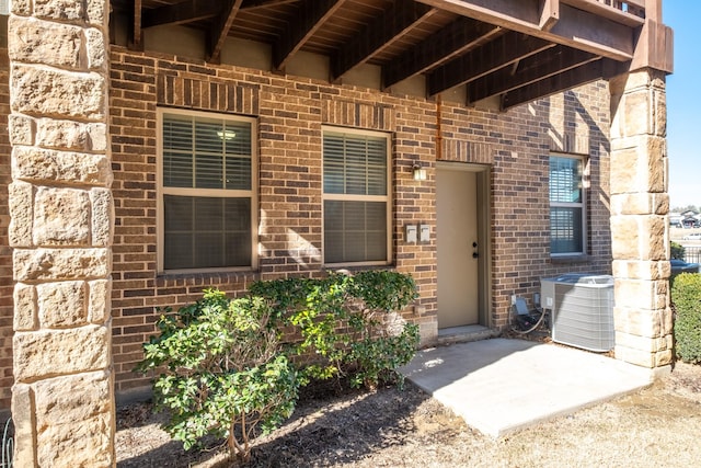 doorway to property with a patio and central air condition unit