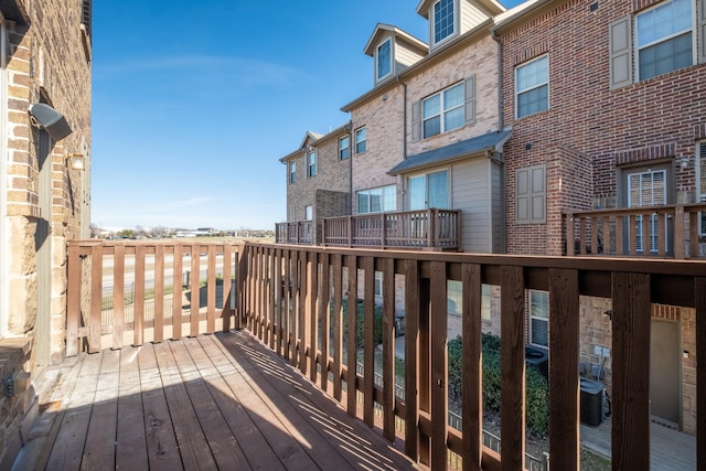 wooden terrace featuring cooling unit