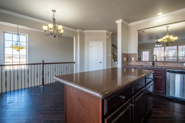 kitchen with sink, dark hardwood / wood-style flooring, a center island, stainless steel dishwasher, and a notable chandelier