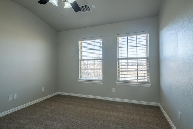 unfurnished room featuring lofted ceiling, ceiling fan, and dark colored carpet