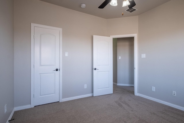 unfurnished bedroom featuring ceiling fan and light colored carpet