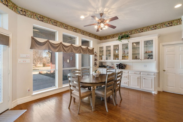 dining area featuring dark hardwood / wood-style flooring, plenty of natural light, and ceiling fan