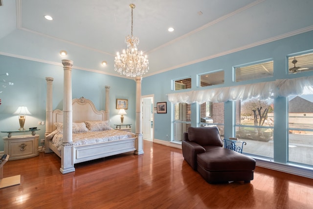 bedroom with hardwood / wood-style floors, ornamental molding, decorative columns, and a raised ceiling