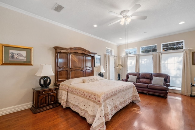 bedroom with ceiling fan, ornamental molding, hardwood / wood-style floors, and a textured ceiling