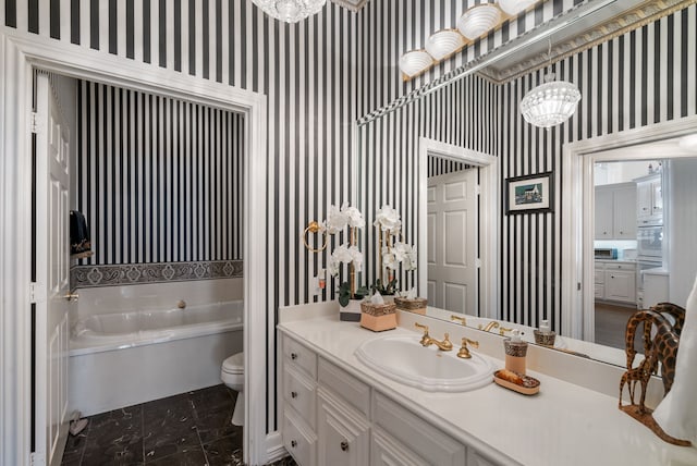 bathroom with vanity, a bath, a chandelier, and toilet