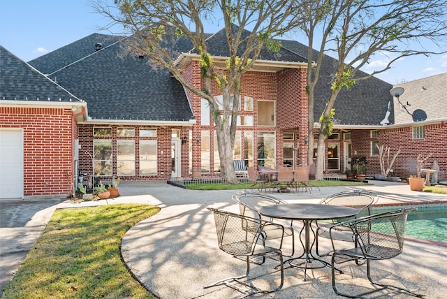 rear view of property featuring a patio area