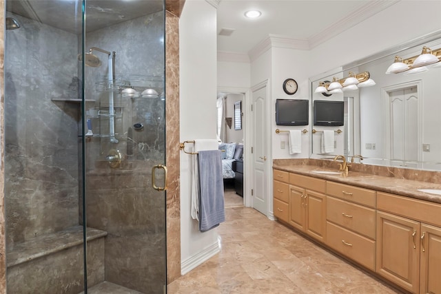 bathroom with ornamental molding, vanity, and a shower with shower door