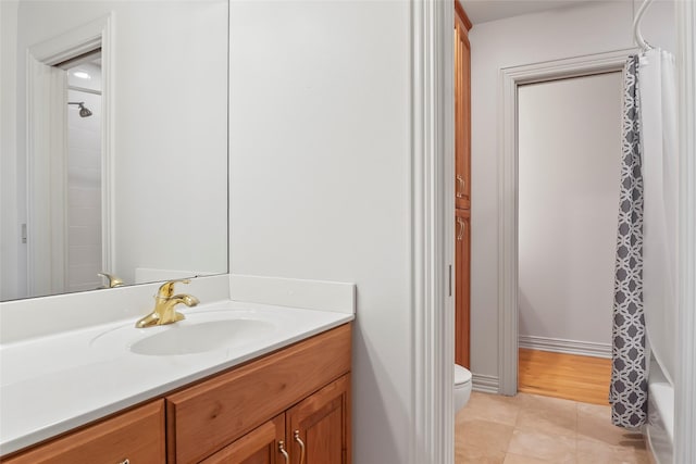 full bathroom featuring shower / tub combo, vanity, toilet, and tile patterned flooring