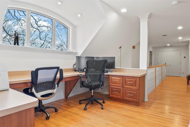 office space with ornate columns and light wood-type flooring