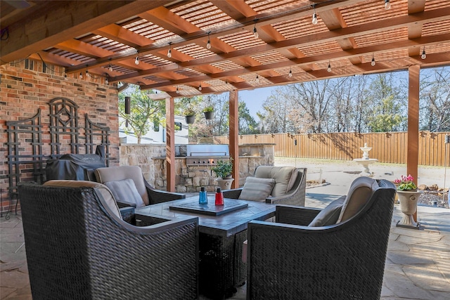 view of patio with area for grilling, grilling area, and a pergola