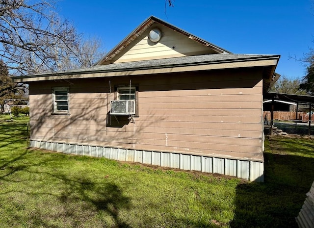 view of side of home with cooling unit and a lawn