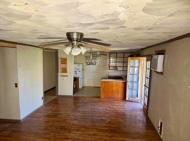 kitchen featuring dark wood-type flooring, ceiling fan, a wall mounted AC, and white fridge