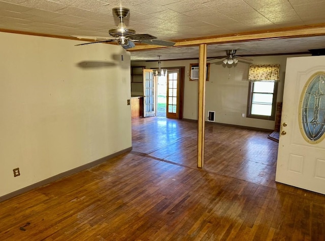 interior space with ceiling fan, hardwood / wood-style flooring, an AC wall unit, and a healthy amount of sunlight