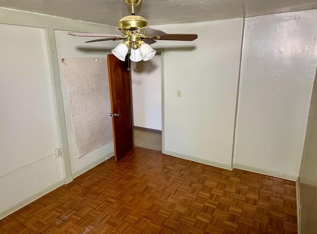 spare room with parquet floors and ceiling fan